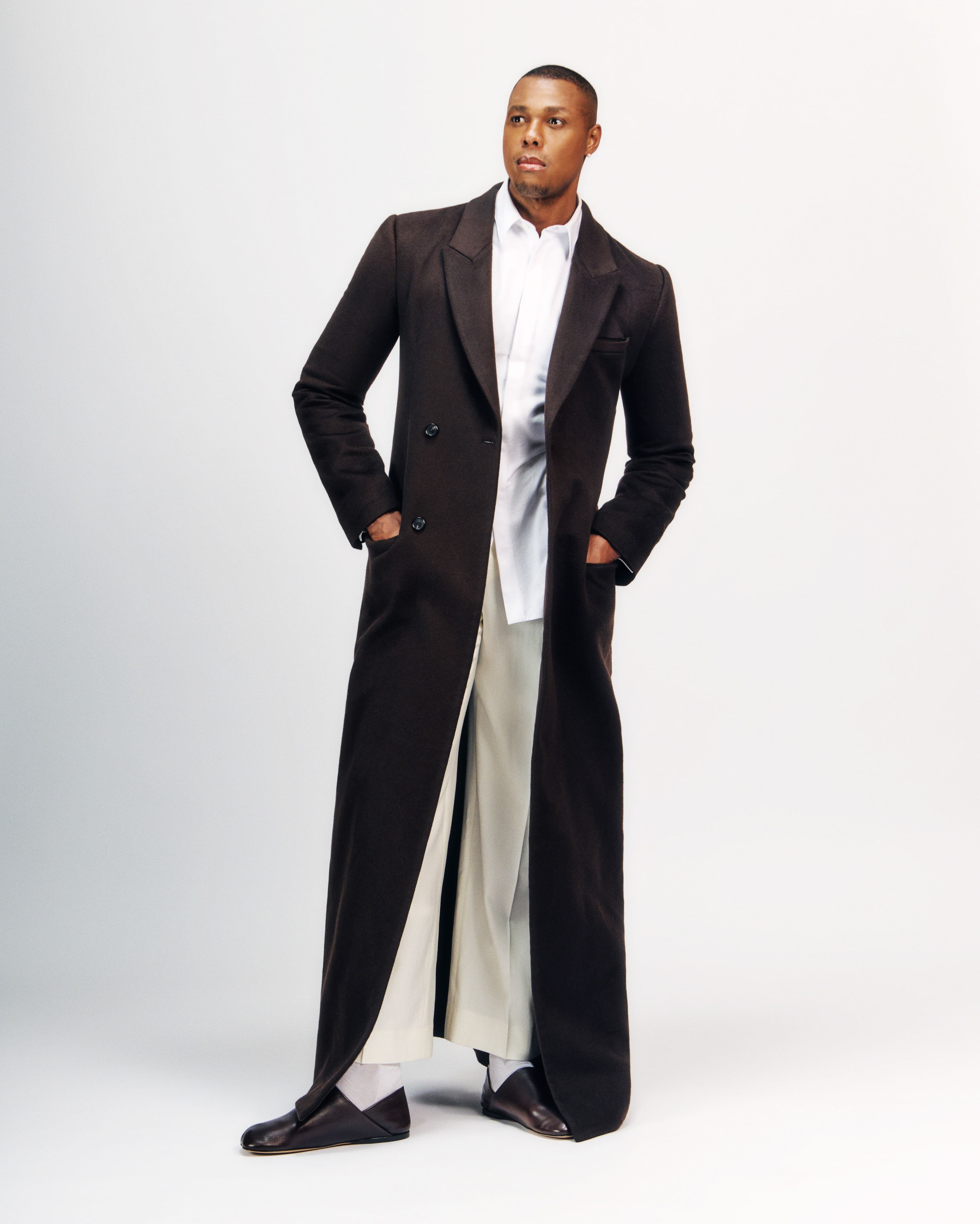 COAT and SHOES by ,Loewe. ,SHIRT by, Hermès. ,PANTS by ,AMI Paris,.