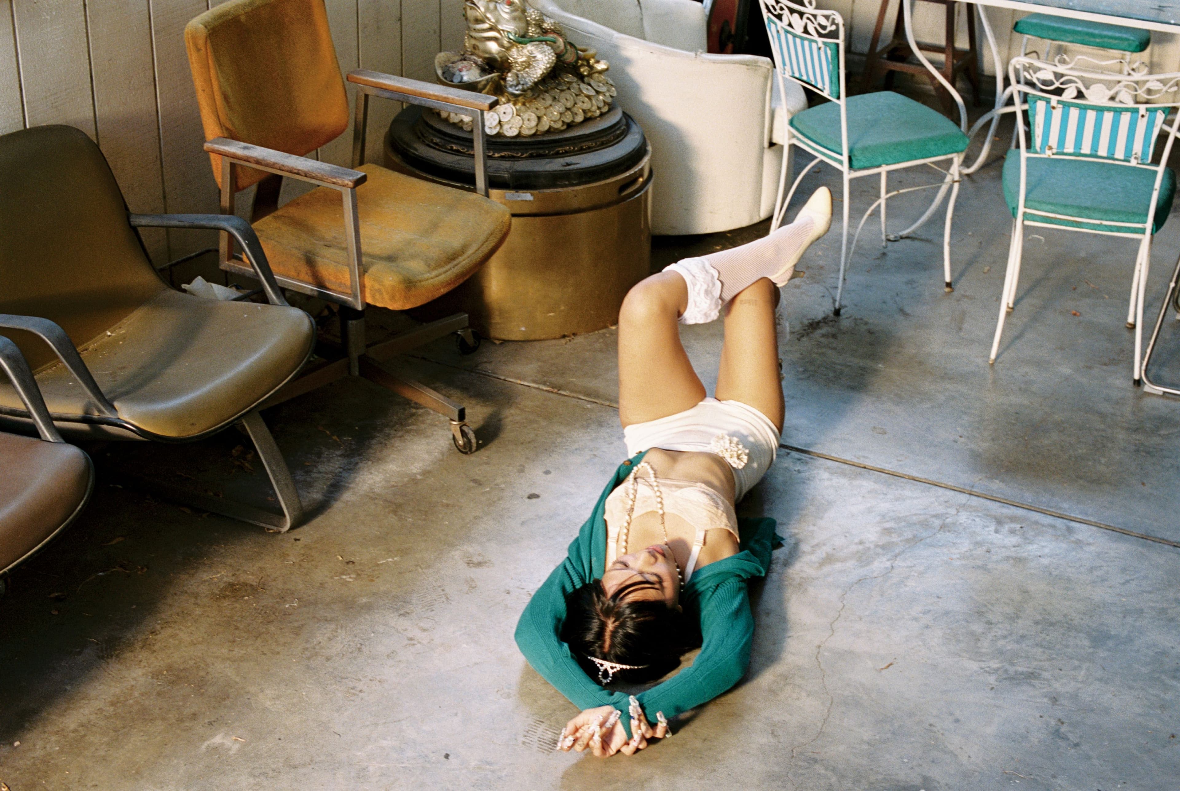 SWEATER by Vivienne Westwood; vintage BRA, SHORTS, and all JEWELRY; SOCKS by Leg Avenue; vintage SHOES by Chanel