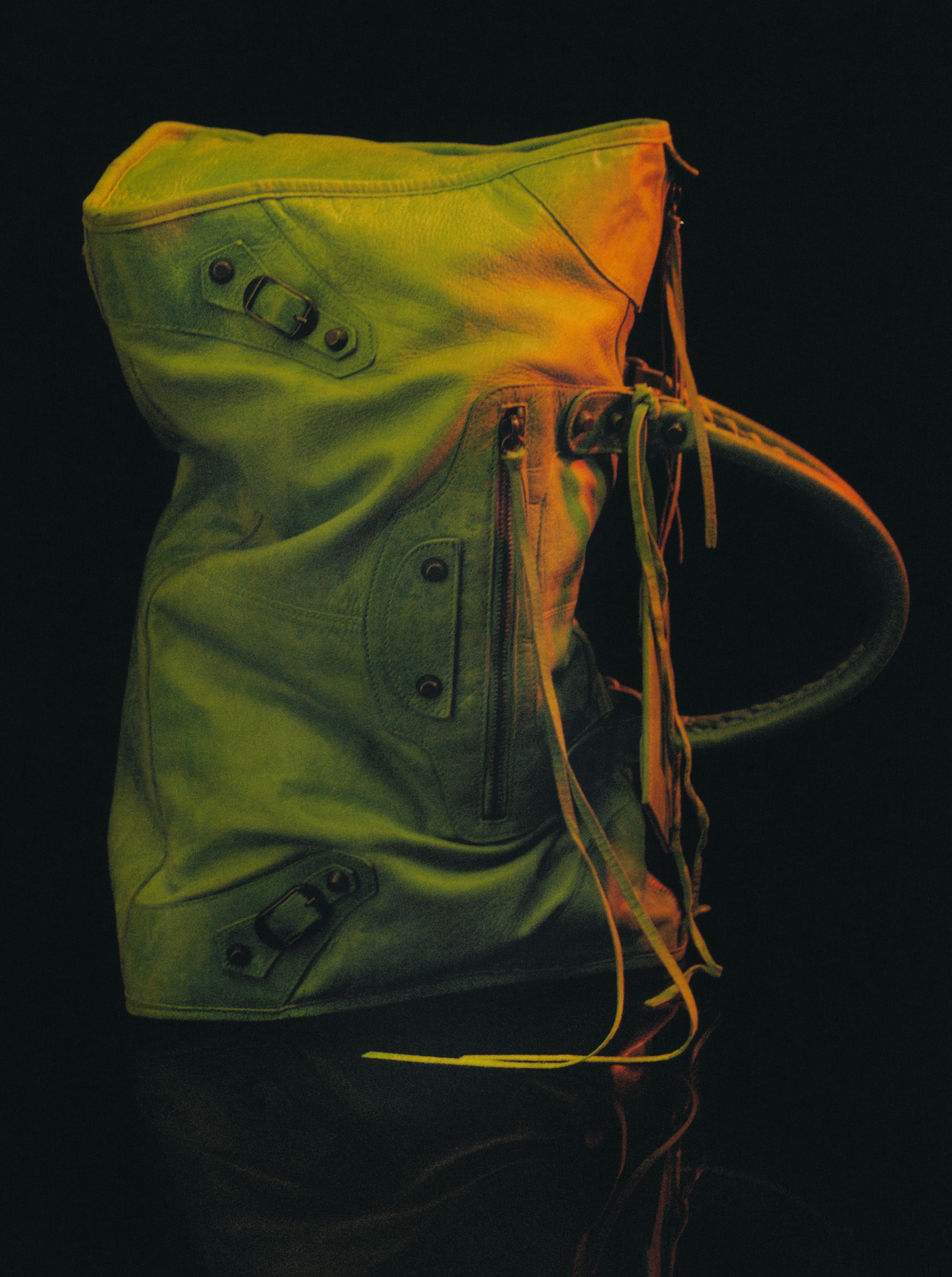 Vintage Le Dix Motorcycle Lariat bag by Balenciaga, Fall 2001.. In 1997, Nicolas Ghesquière revived the house of Balenciaga at the age of twenty-five. Originally a runway prototype with only twenty-five initially produced, the soft and studded Motorcycle bag was a cult aughts icon, favored by Emmanuelle Alt, Carine Roitfeld, Kate Moss, and Mary-Kate and Ashley Olsen. A testament to Ghesquière’s innate capacity to distill the ultimate cool girl chic, the piece remains coveted twenty-two years later, now reworked by the current creative director of Balenciaga, Demna.