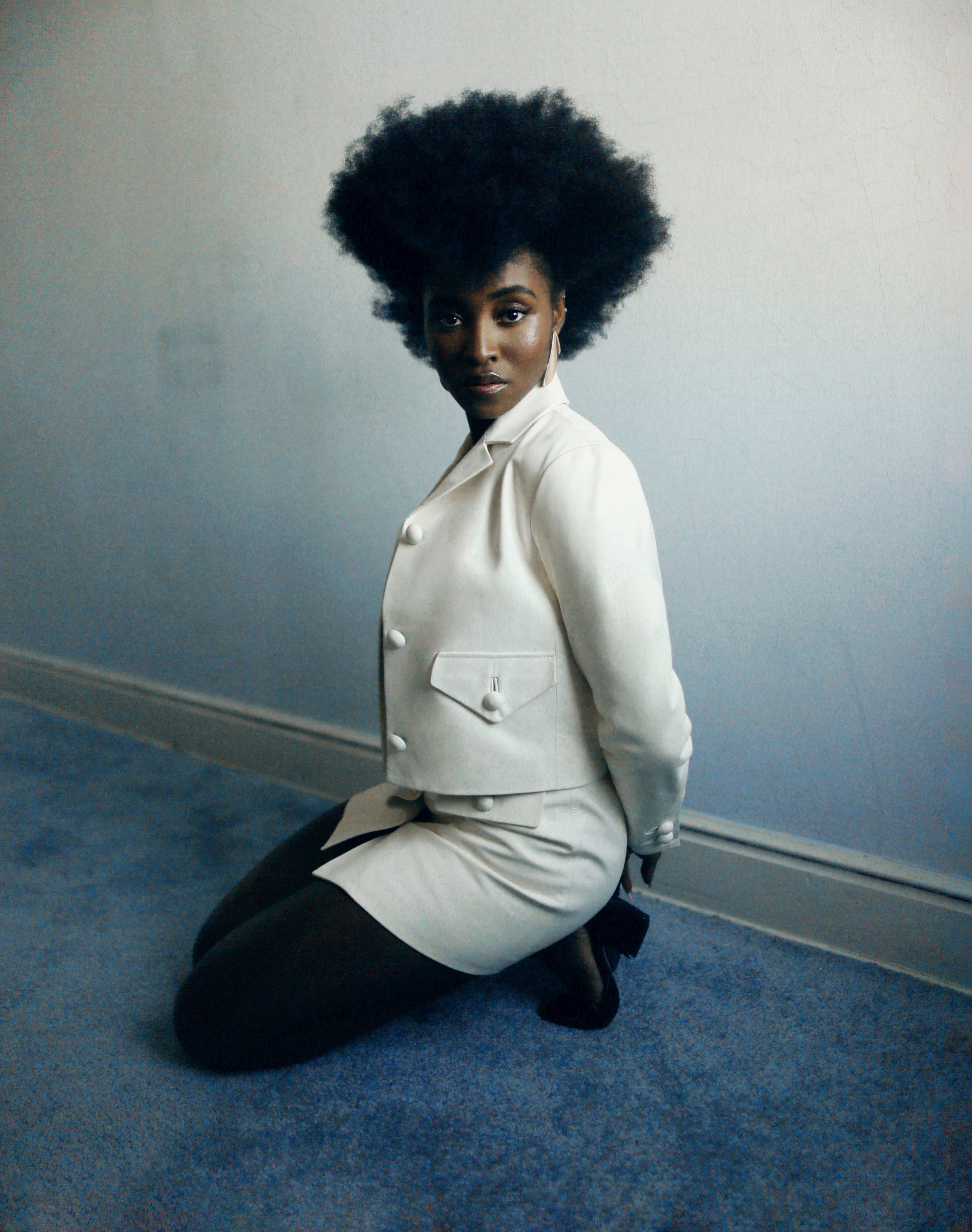 Jacket and skirt by Dior. Vintage shoes by Valentino from the Albright Fashion Library. Earrings by Tiffany & Co.