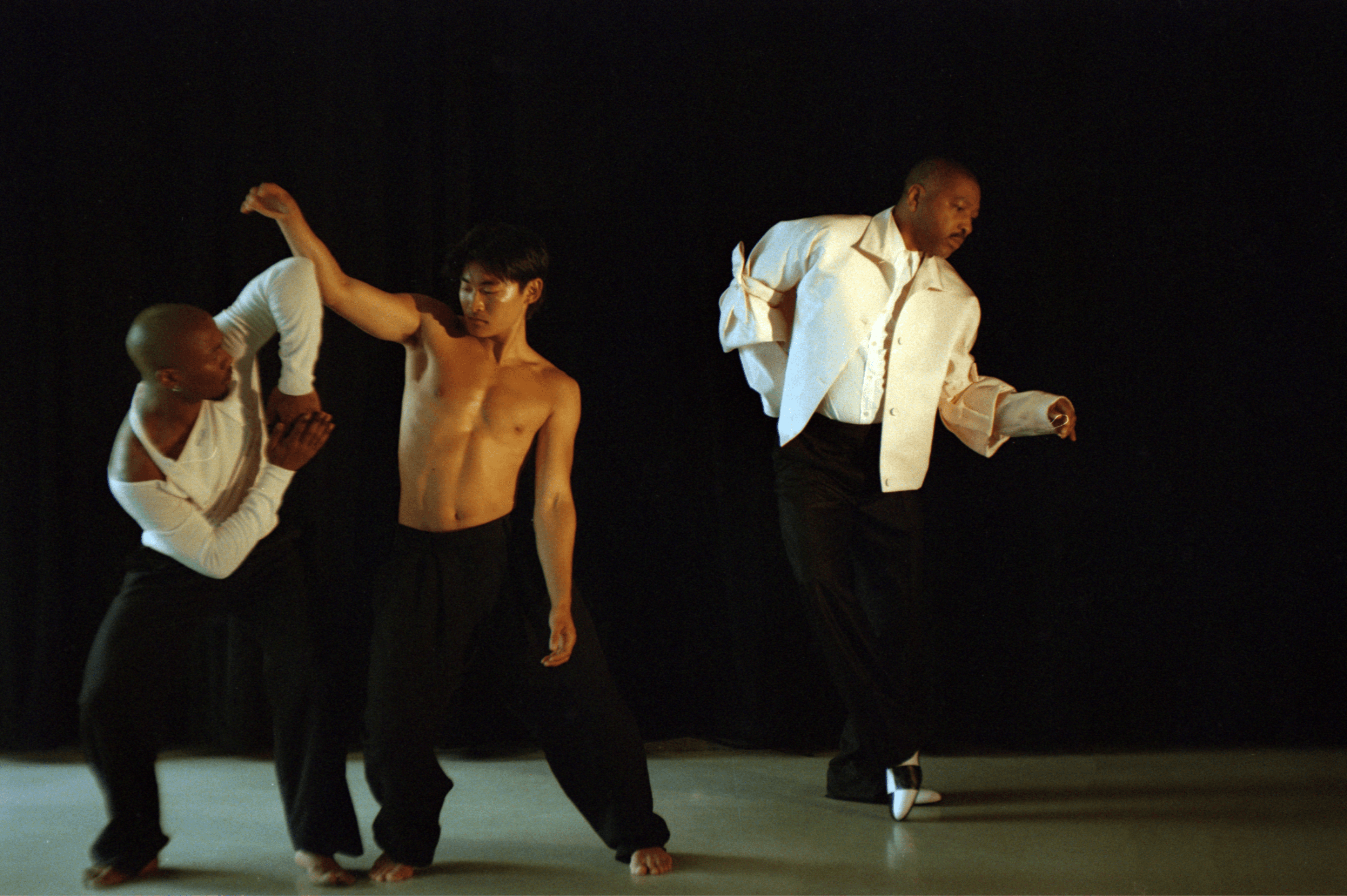 FROM LEFT: Jamaal Bowman wears TOP by Dior,; ,PANTS by Dries Van Noten,. ,William Okajima wears PANTS by Ferragamo. Kyle Abraham wears JACKET and PANTS by Dior; SHIRT by Dries Van Noten; SHOES by Manolo Blahnik.