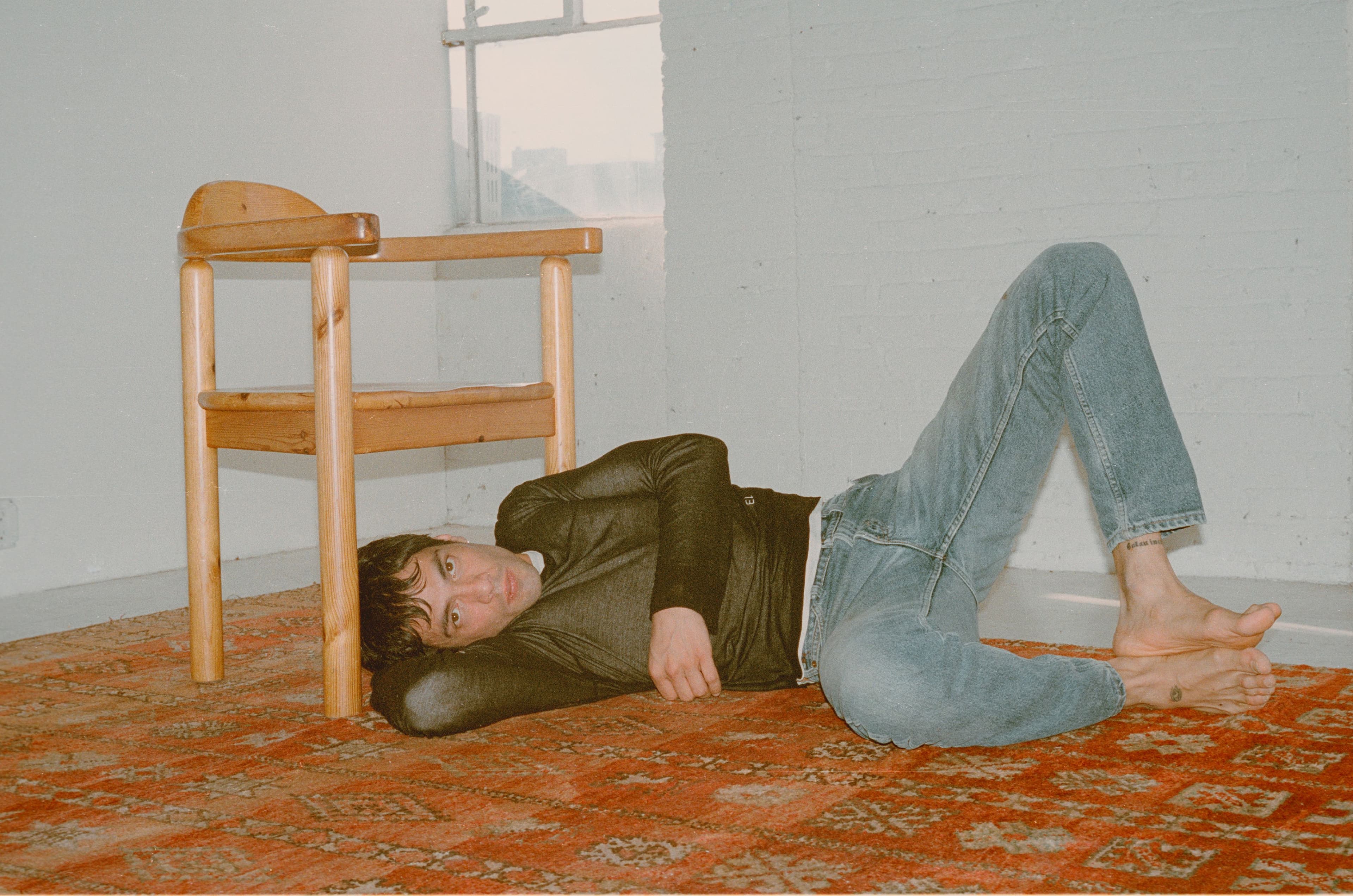 TOP by Eckhaus Latta; vintage JEANS by Levi’s from The Society Archive; SHOES by Prada