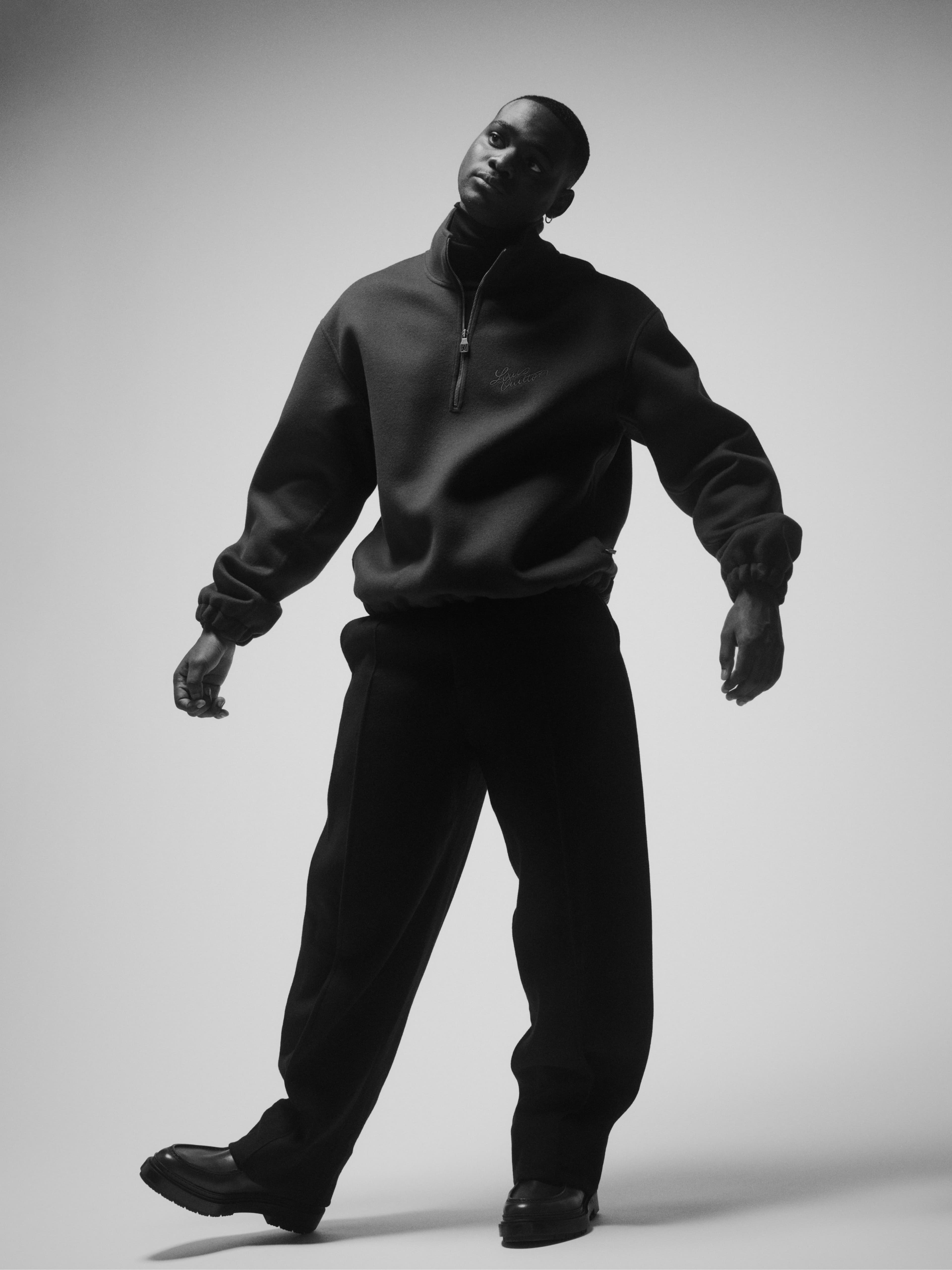 SWEATSHIRT by ,Louis Vuitton., SWEATER, worn underneath, stylist’s own. PANTS and SHOES by ,Zegna.