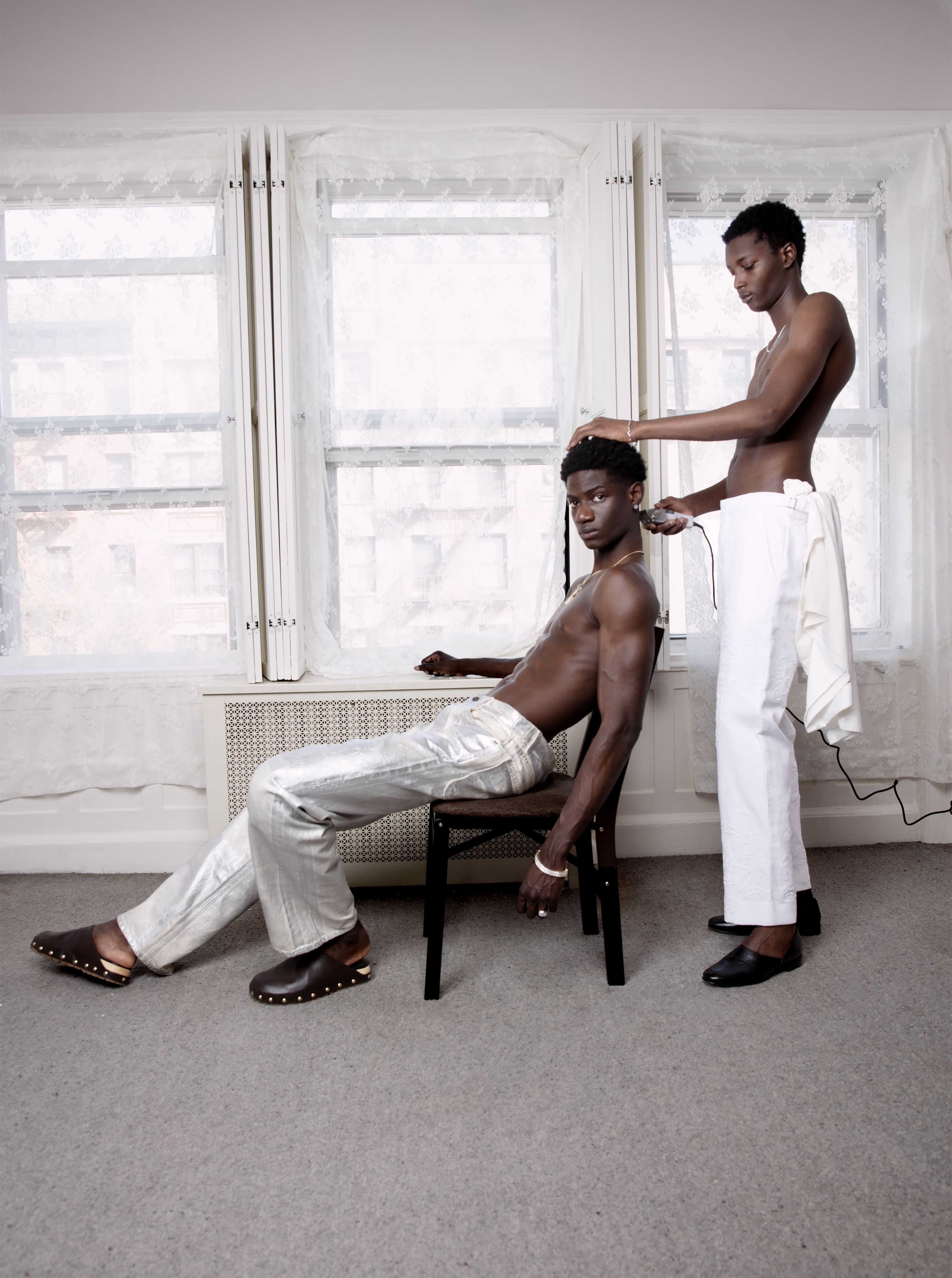 From left: Amoah wears pants and shoes by Jacquemus. All jewelry, Amoah’s own. Gueye wears pants and shoes by Bode. All jewelry, Gueye’s own.