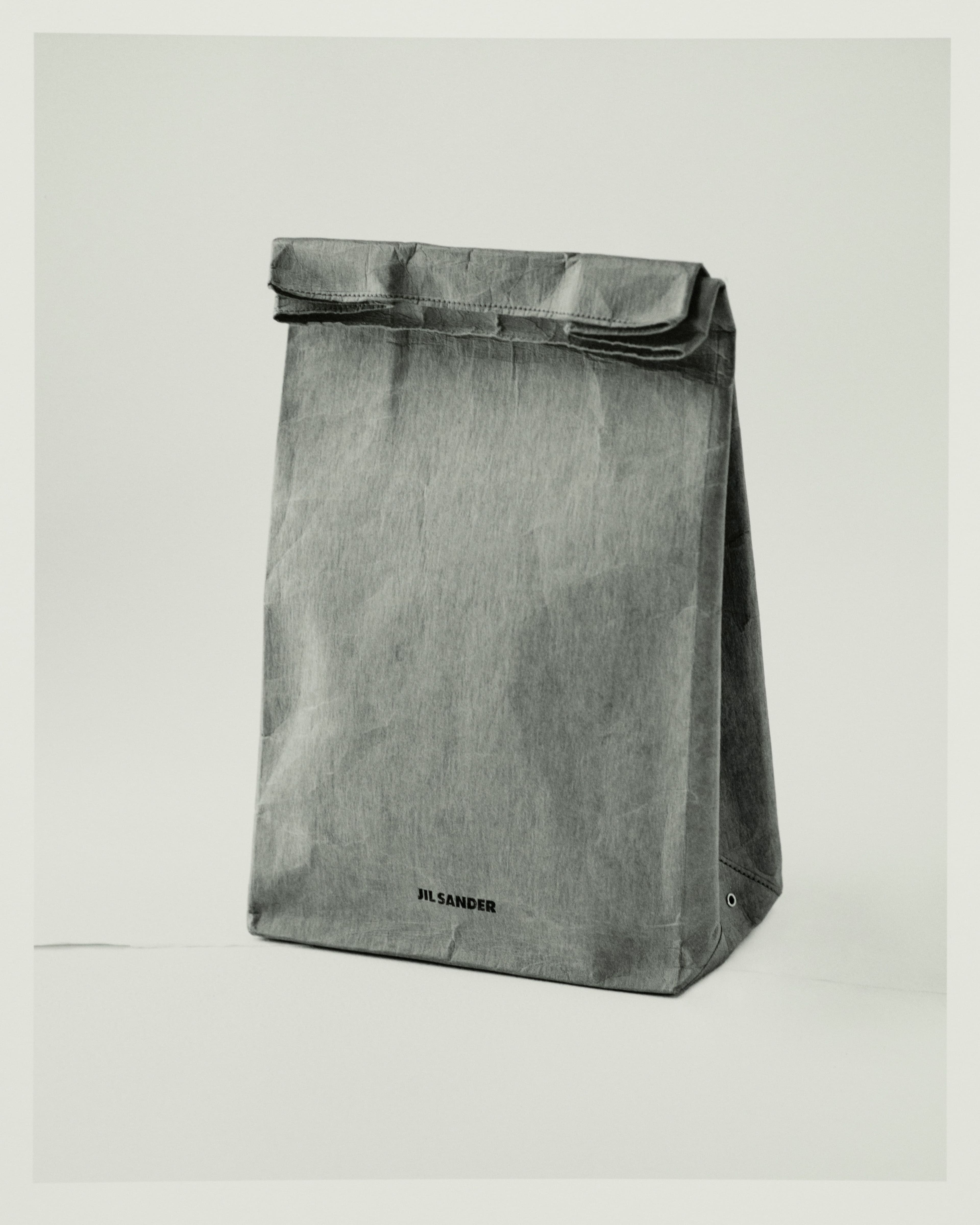 Vintage bag by Jil Sander, Fall 2012, from the David Casavant Archive. In a collection largely composed of black, Raf Simons injected playful reinterpretations of menswear, including this lunchtime paper bag, which elevates a staple of office life.