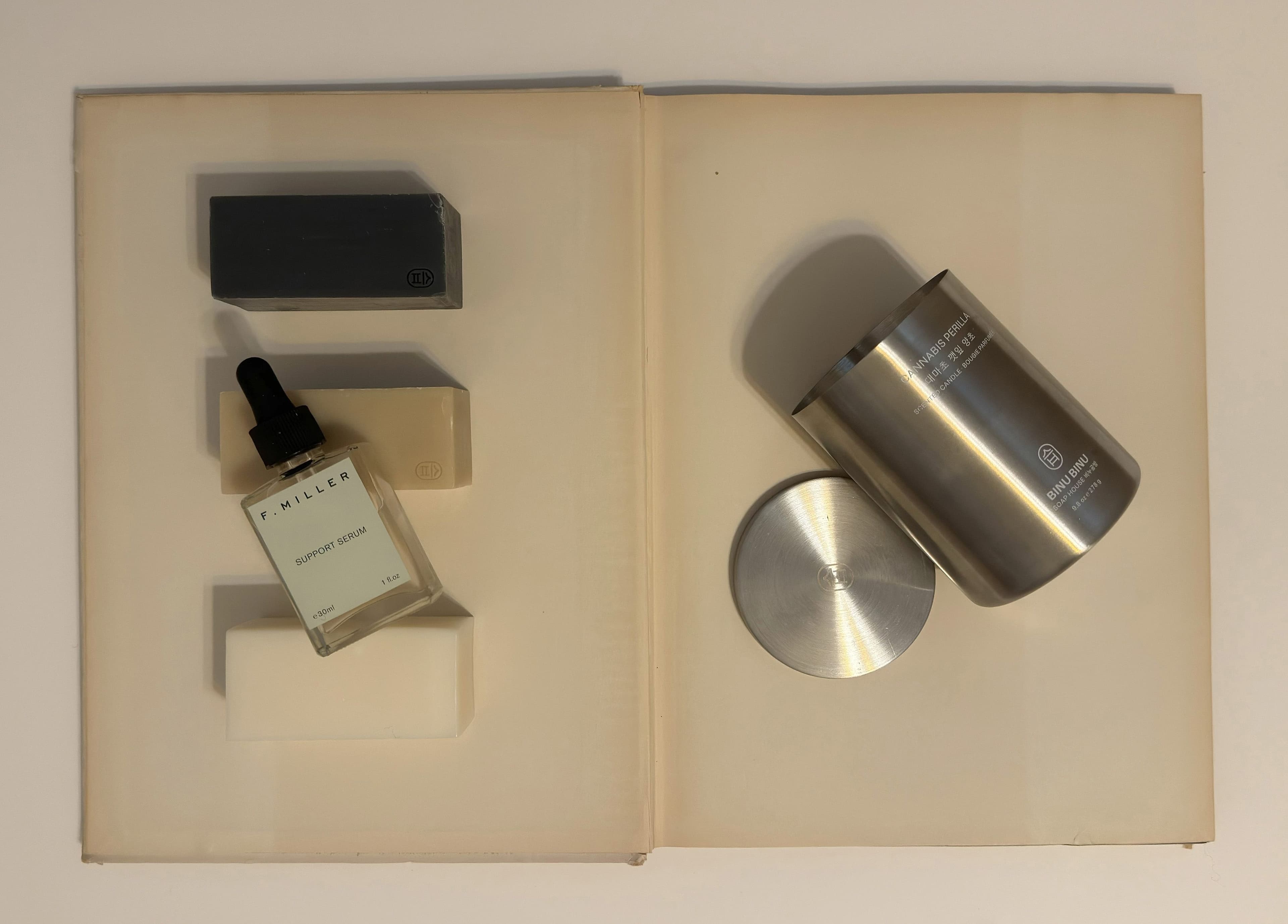 FROM LEFT: SOAPS by ,Binu Binu. ,SUPPORT SERUM by ,F. Miller. ,CANDLE by ,Binu Binu.