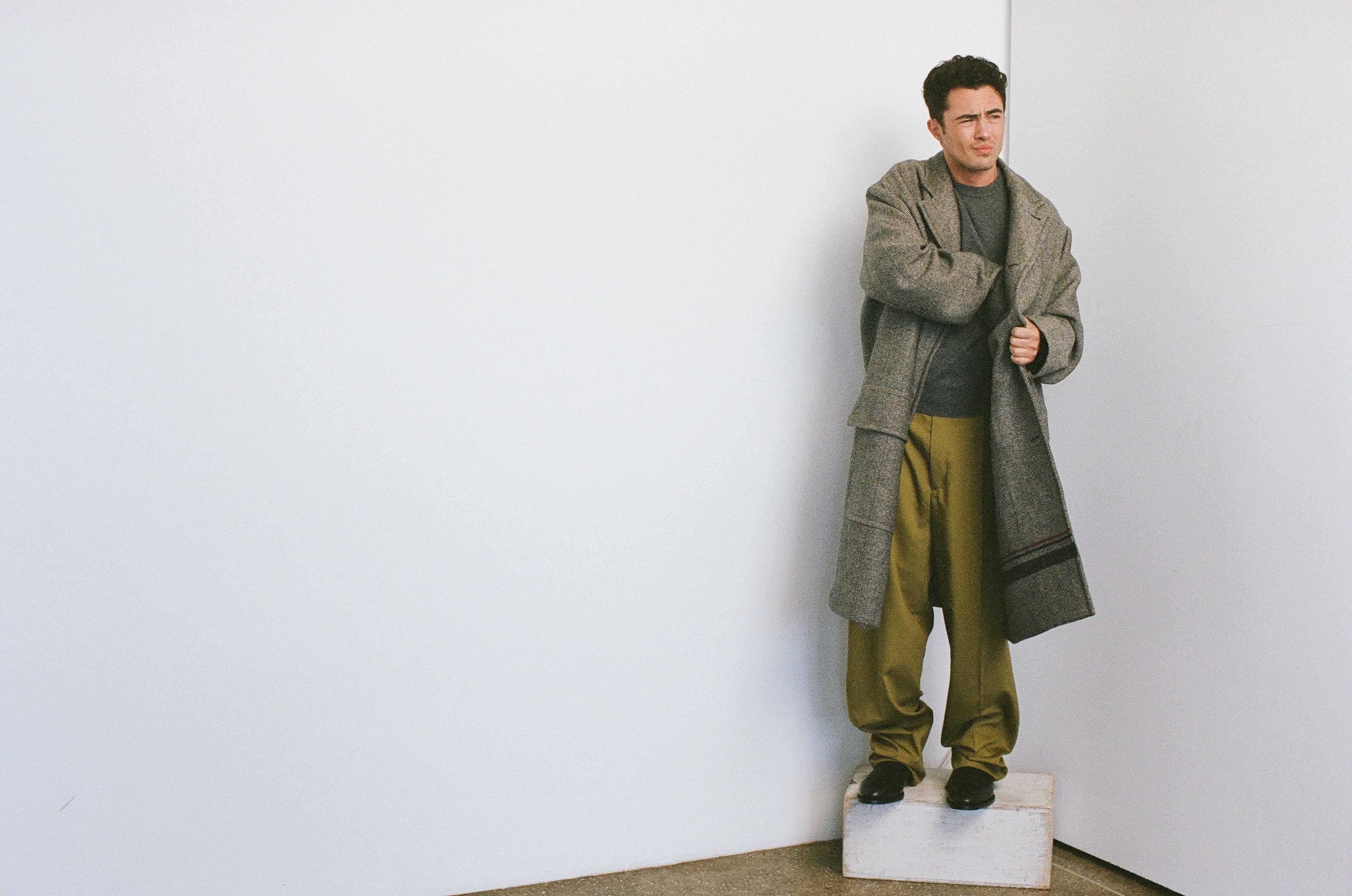 COAT by Hermès; SWEATER by Michael Kors; PANTS and SHOES by Zegna