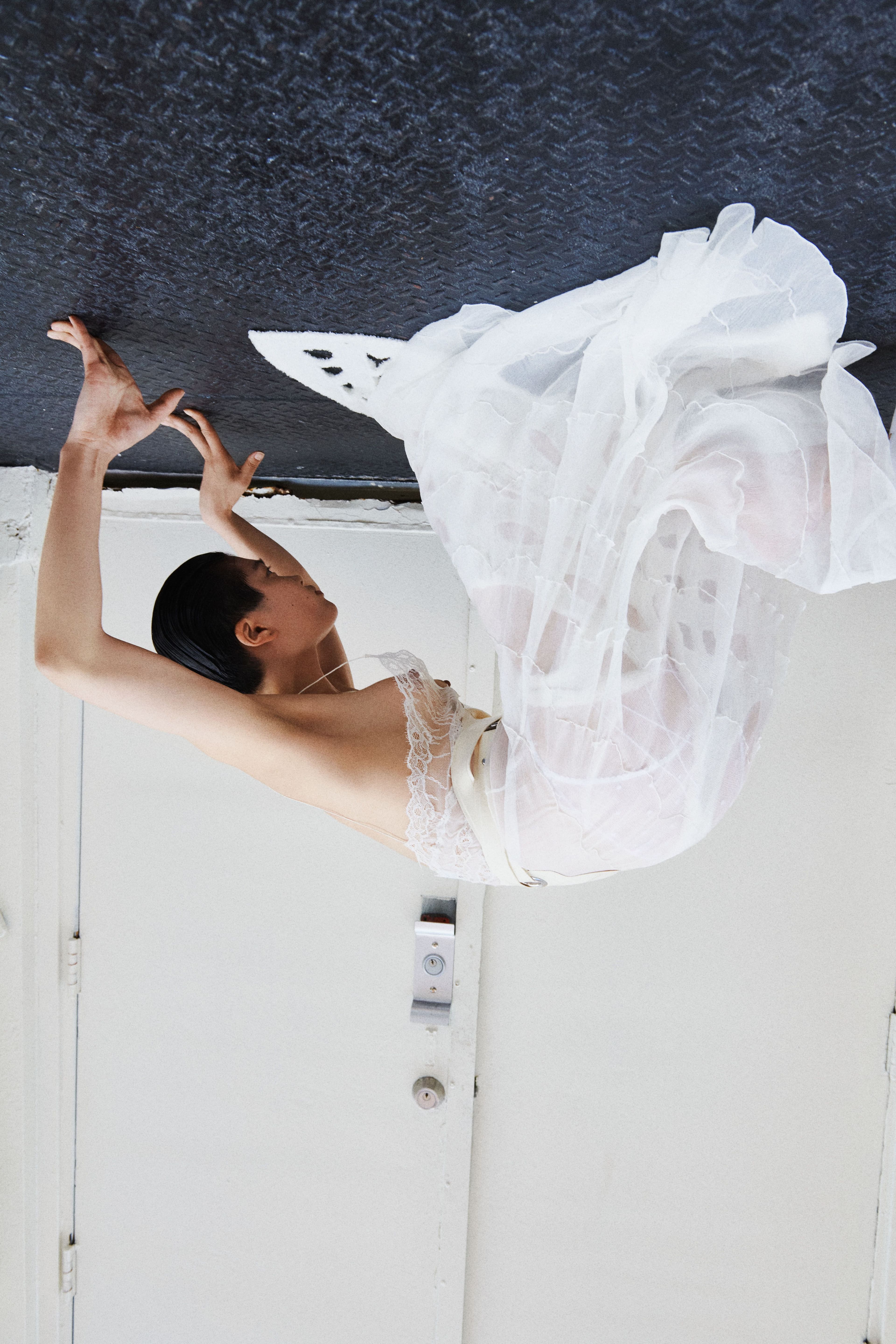 Apron by Kwaidan Editions. Dress by Saint Laurent. Skirt, worn underneath, by Gabrielle Schwan. Underwear by Agent Provocateur.