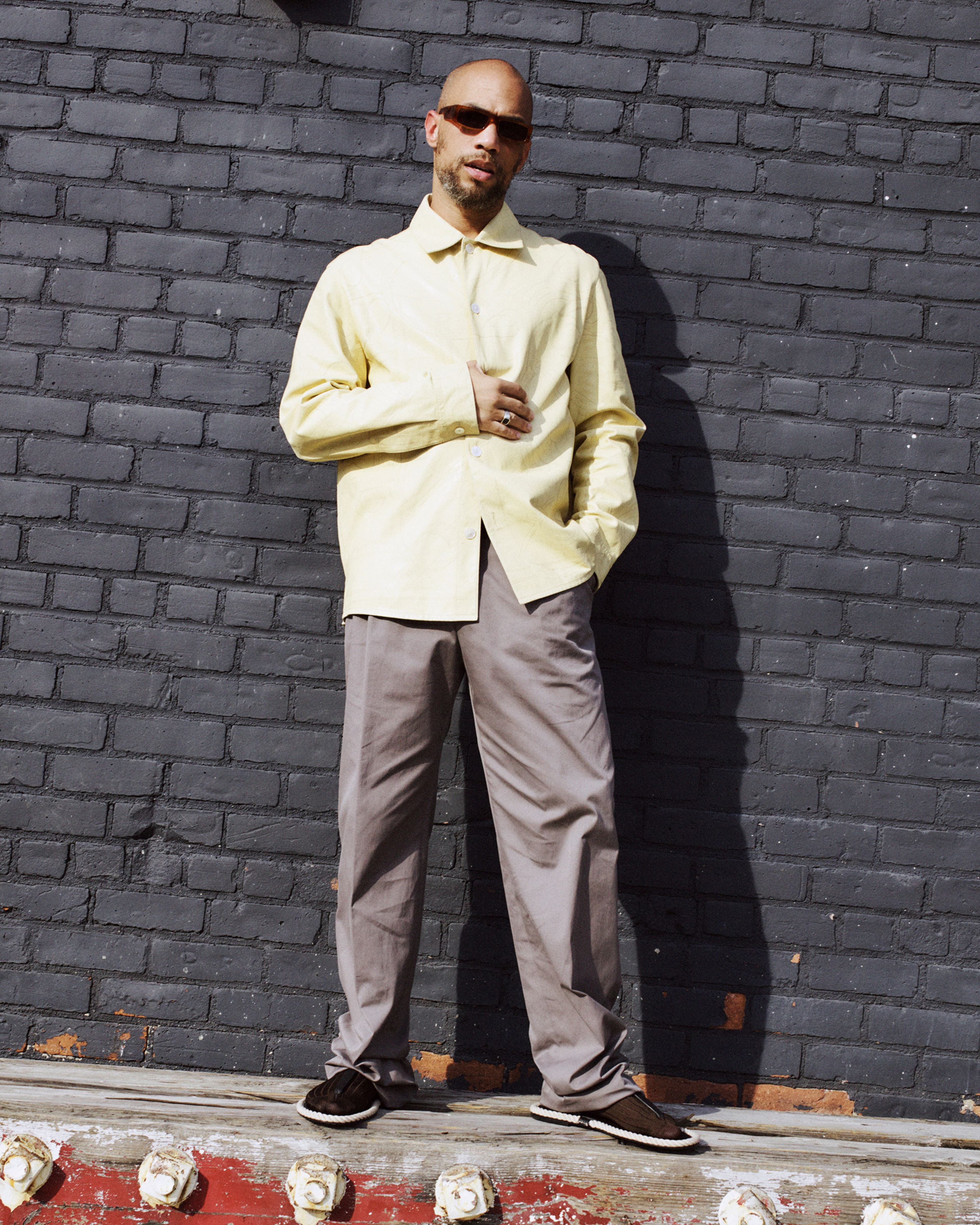All CLOTHING and SHOES by Hermès; SUNGLASSES by Andy Wolf; SOCKS by Bottega Veneta