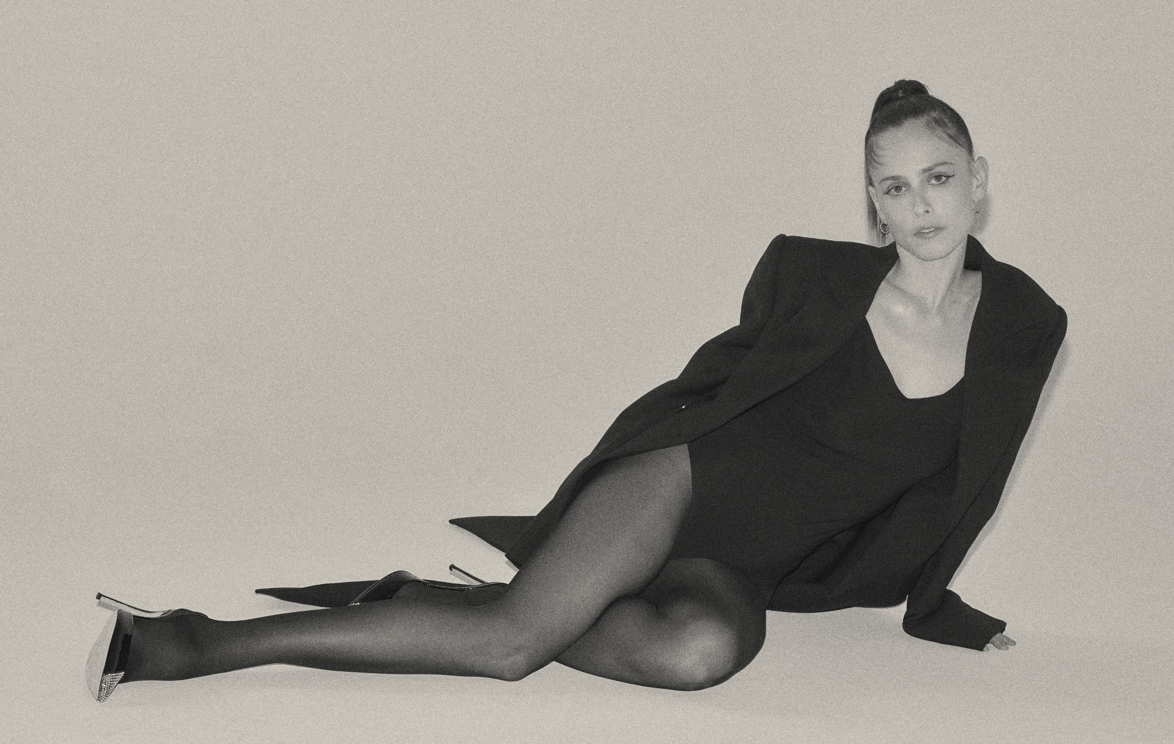 Coat by Alexander McQueen. Bodysuit by Commando. Tights by Calzedonia.