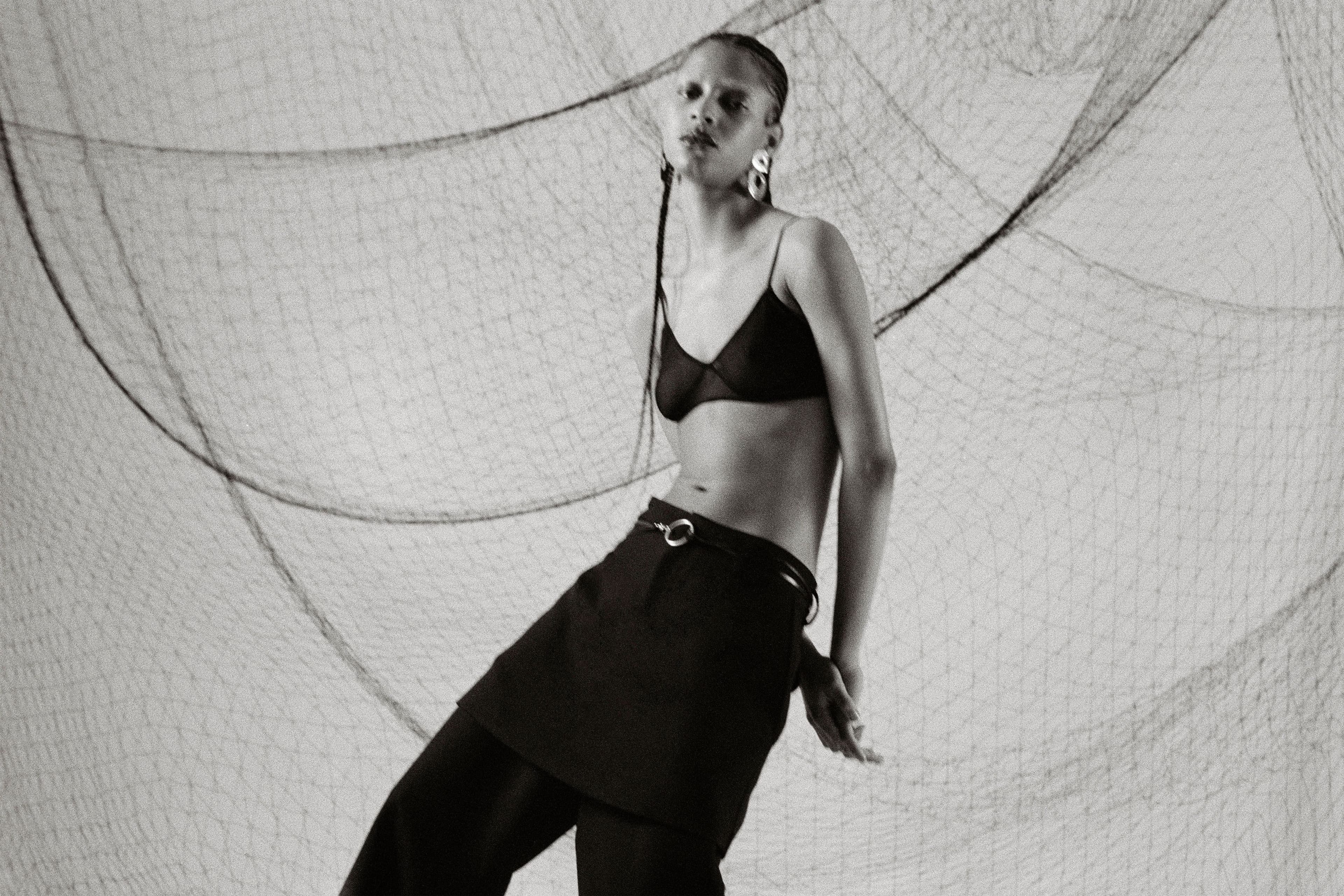 Bra by Helmut Lang. Pants by Altu. Belt and ring, stylist’s own. Earrings by Leigh Miller.