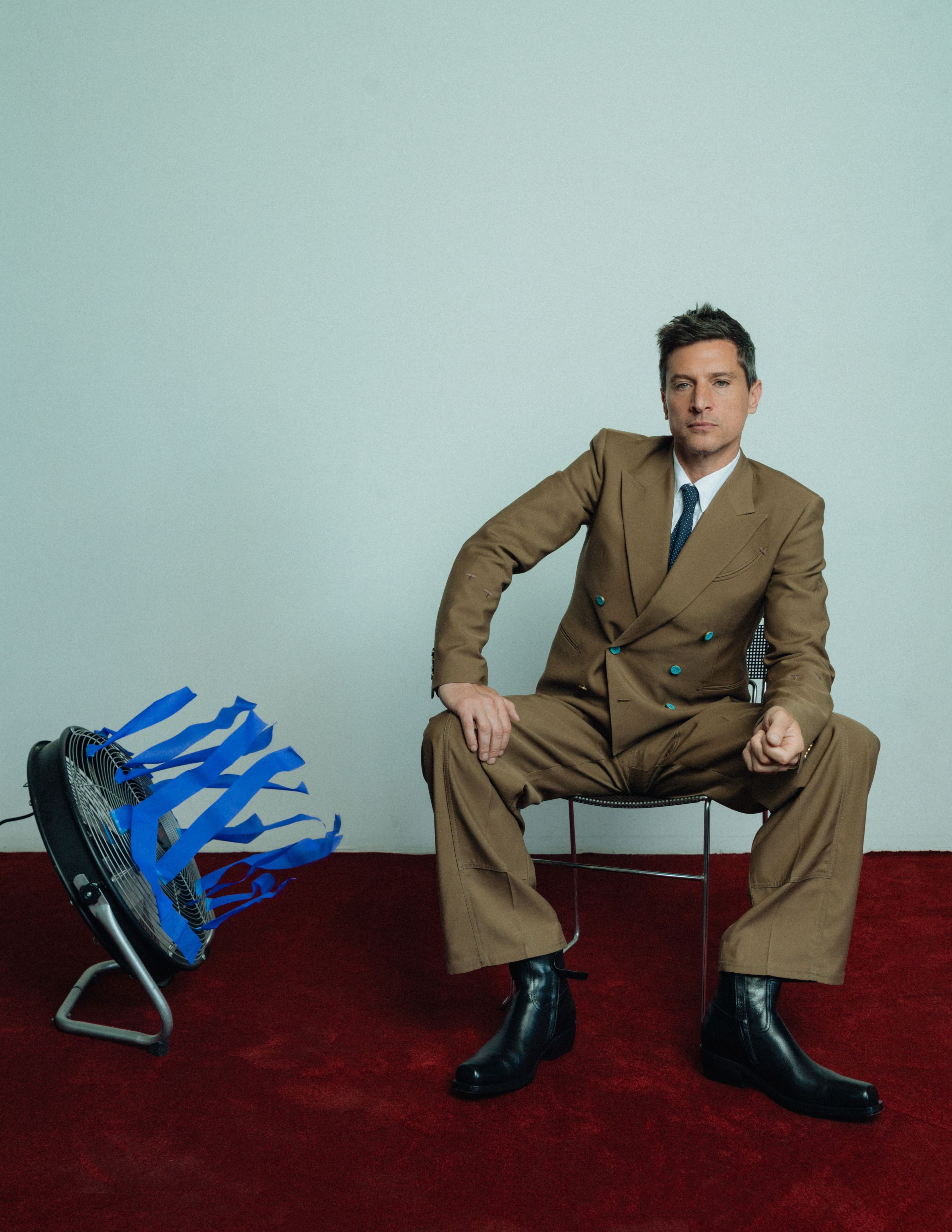 All CLOTHING by ,Louis Vuitton., TIE by ,Balenciaga., BOOTS by ,Versace.