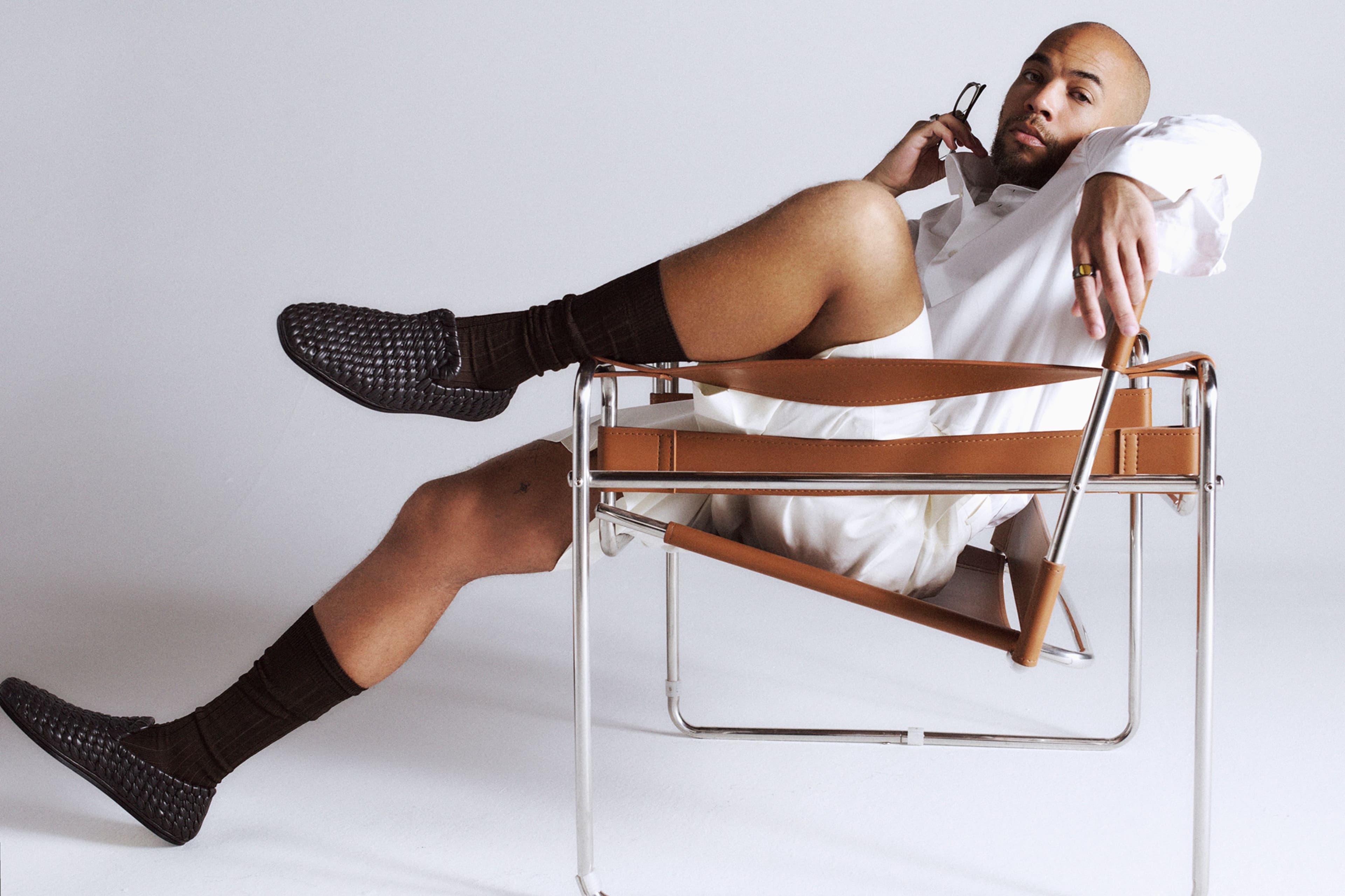 All CLOTHING, SOCKS, and SHOES by Bottega Veneta; vintage GLASSES, in hand, from Fabulous Fanny’s