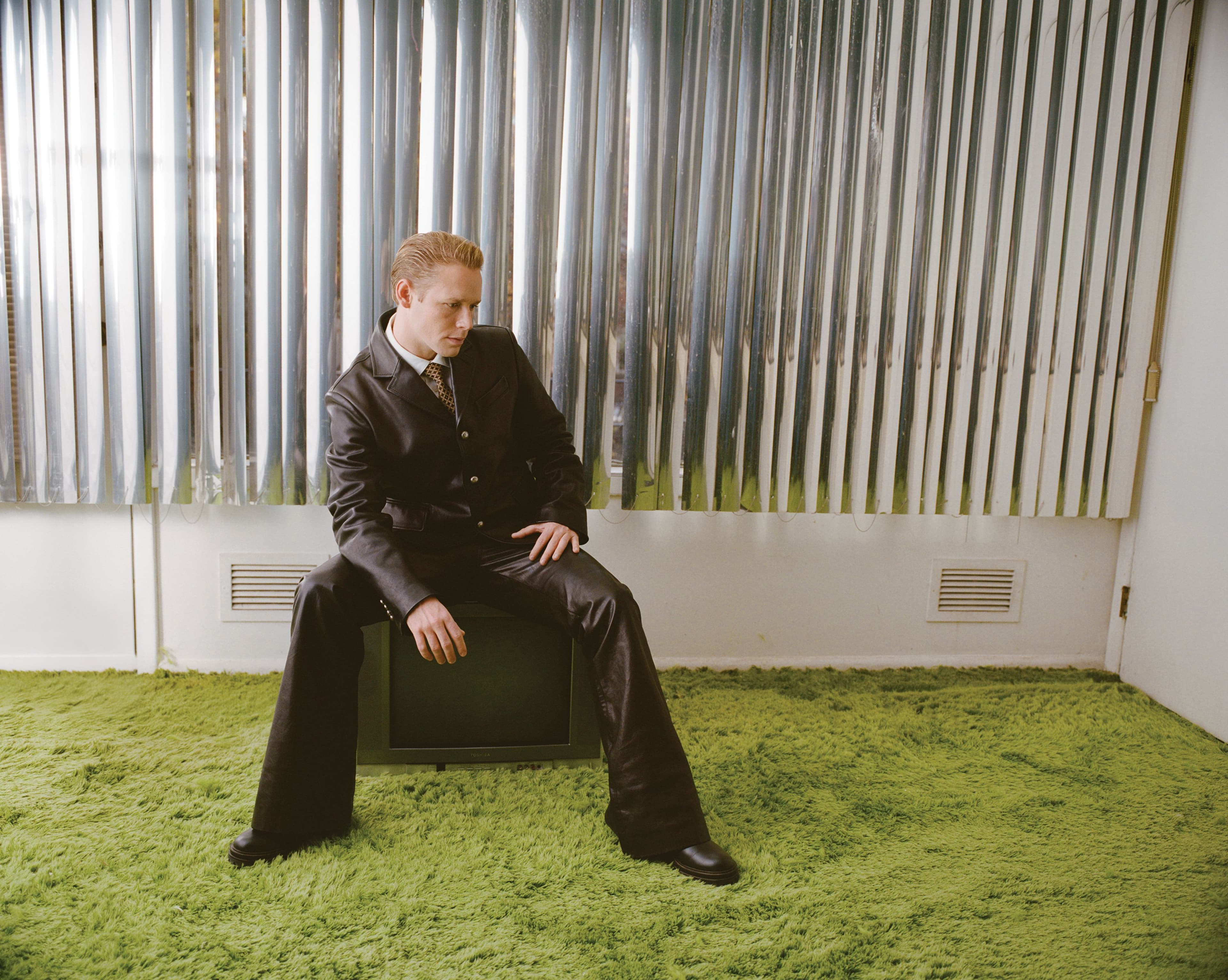 All CLOTHING and TIE by Louis Vuitton; BOOTS by Gianvito Rossi