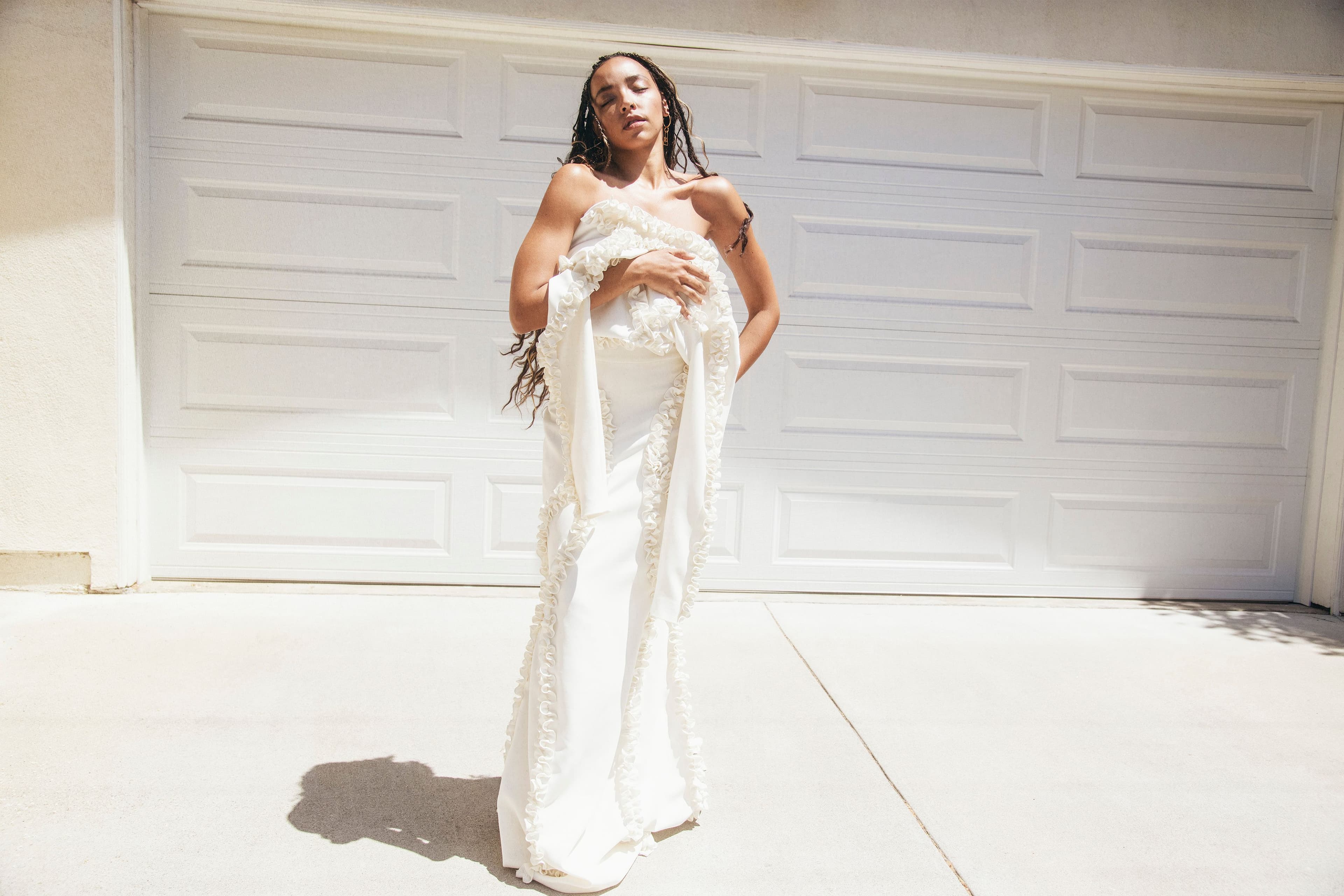 Dress by Christian Siriano. Shoes by Gucci. Earrings by Jacquemus.