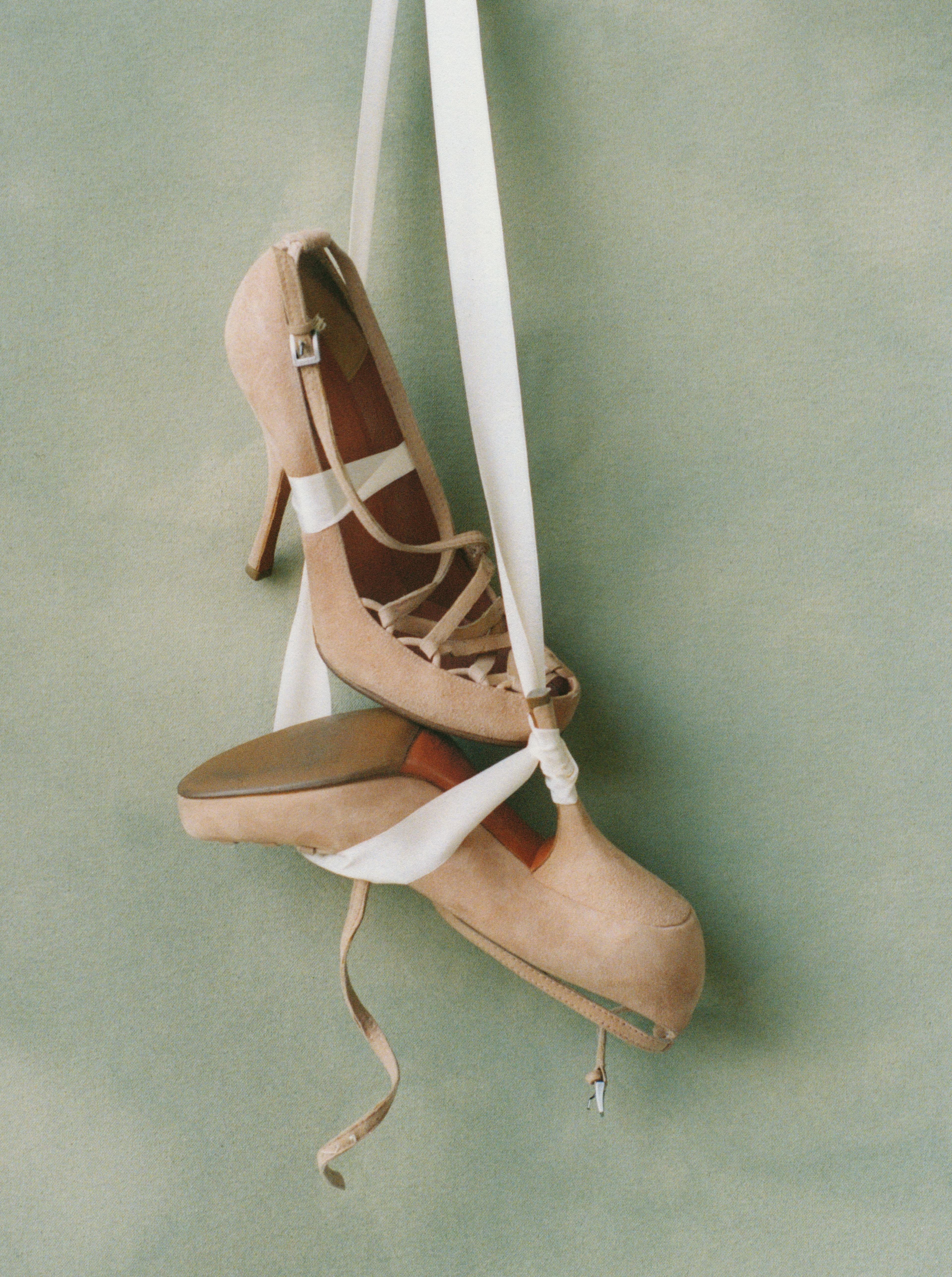 Vintage shoes by Alaïa, year unknown.. Trained as a sculptor at the Institut Supérieur des Beaux-Arts de Tunis, Azzedine Alaïa celebrated the strength and contours of the female form with exaggeration and compression, leveraging the tools of release and resistance. The crisscrossed laces over the toe cleavage, paired with the supple brushed pink suede and fetish-inspired curved heel, serve as an exemplary model of classic Alaïa coding.