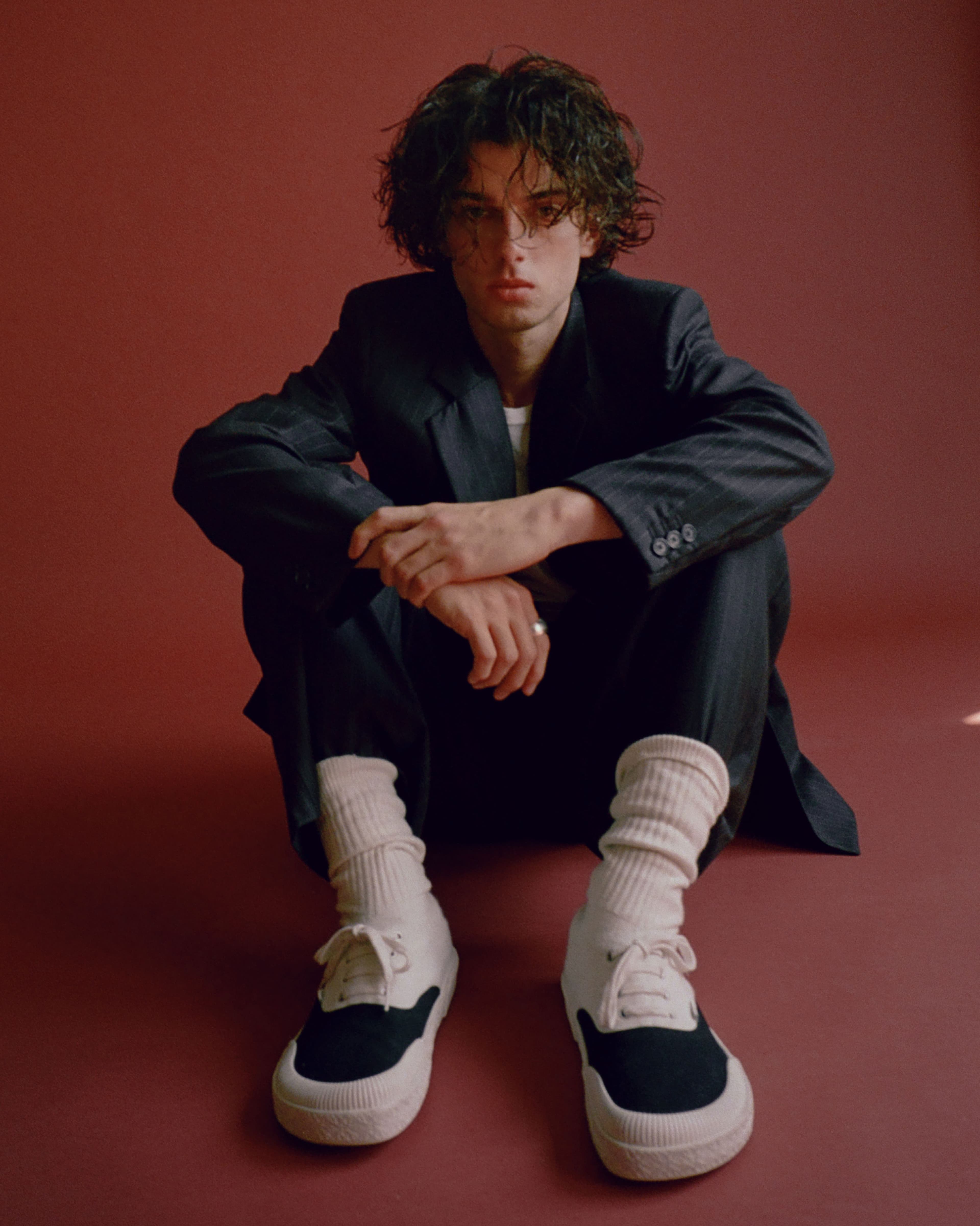 JACKET, PANTS, and SHOES by ,Loewe. ,T-SHIRT, stylist’s own. NECKLACE by ,Miansai.