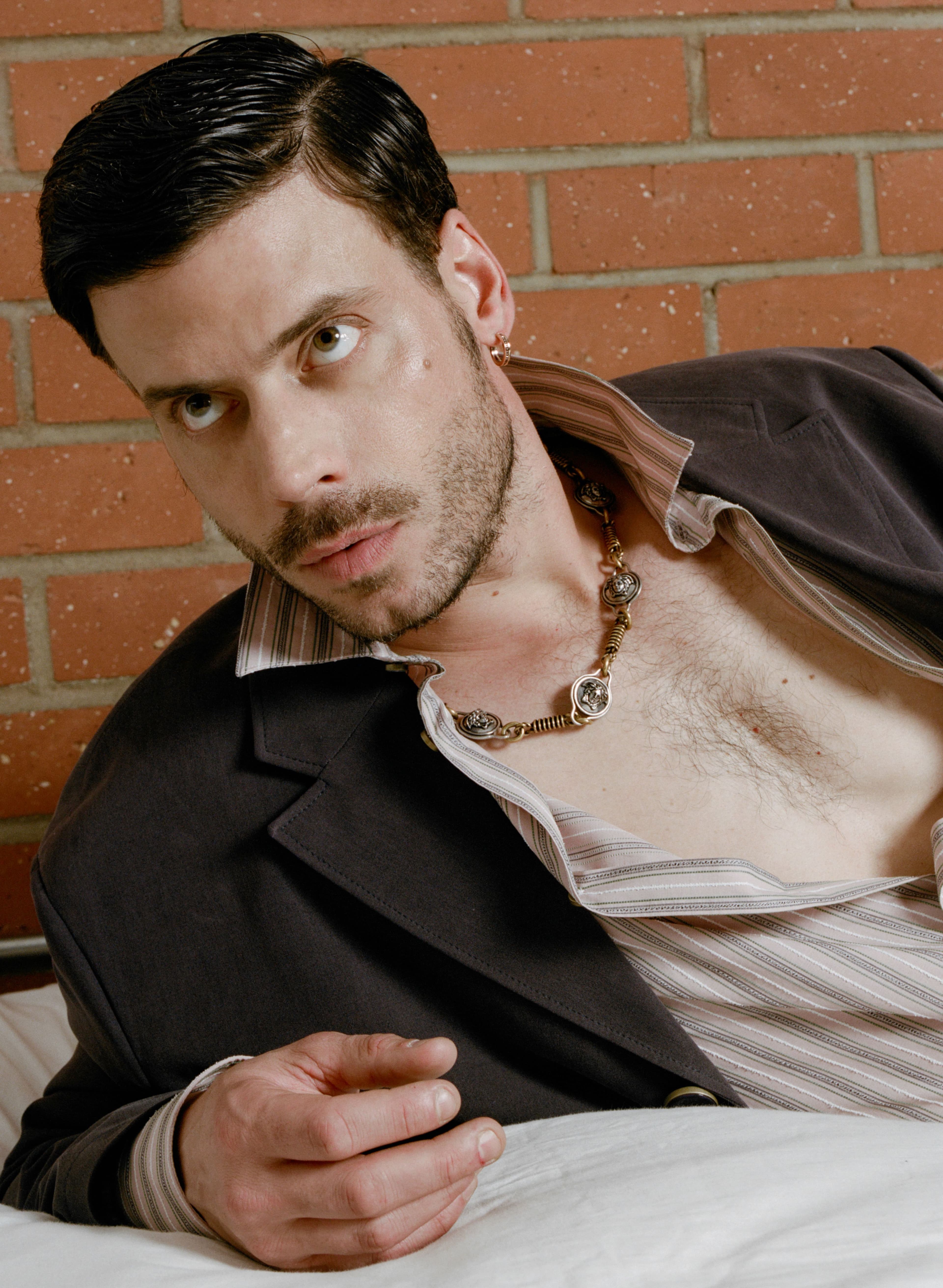 All CLOTHING by Louis Vuitton; CHAIN, worn as necklace, by Versace; EARRING by Boucheron