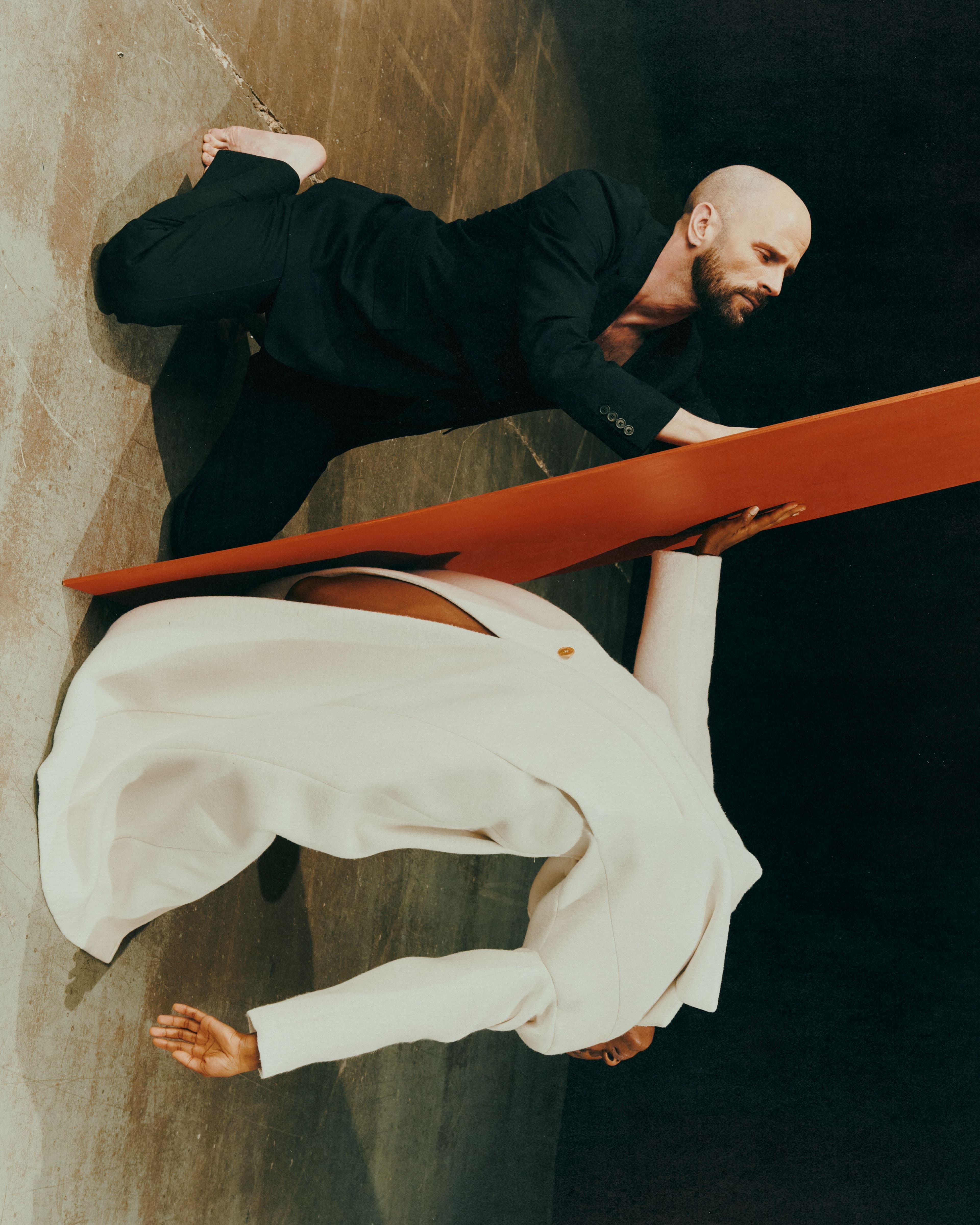 FROM TOP: Christopher wears SUIT by ,Dries Van Noten. ,Lucieny wears COAT by ,GCDS.